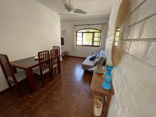 a living room with a table and a dining room at Caribean Praia das Toninhas - A 100 metros da areia 21A in Ubatuba