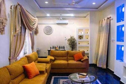 a living room with a couch and a table at Adji's Cozy Villa in Apenkwa