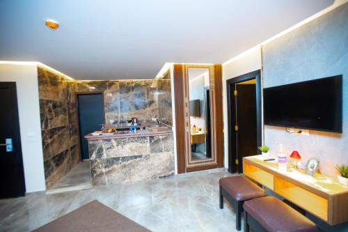 a large bathroom with a television and a sink at New Comfort Inn Giza in Cairo