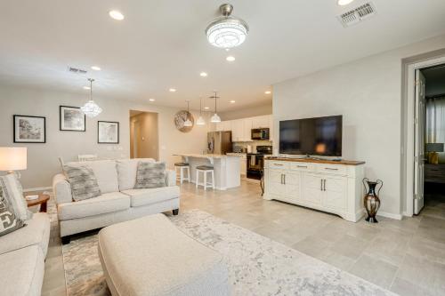 a living room with a couch and a tv at Central Casa Grande Home in Quiet Neighborhood in Casa Grande