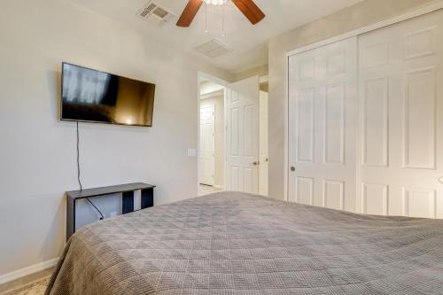 a bedroom with a bed and a flat screen tv on a wall at Central Casa Grande Home in Quiet Neighborhood in Casa Grande
