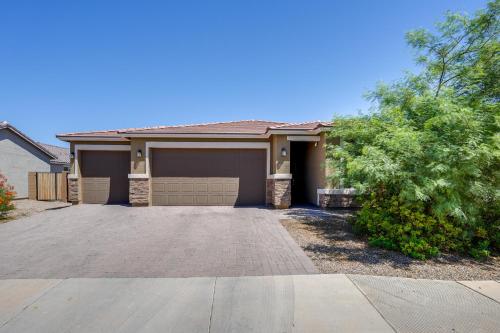 a house with a driveway in front of it at Central Casa Grande Home in Quiet Neighborhood in Casa Grande