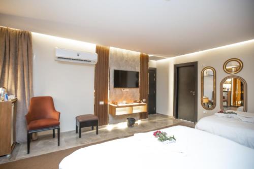 a hotel room with a bed and a chair at New Comfort Inn Giza in Cairo