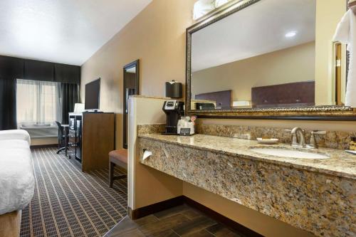a hotel room with a sink and a mirror at Best Western Plus Yakima Hotel in Yakima