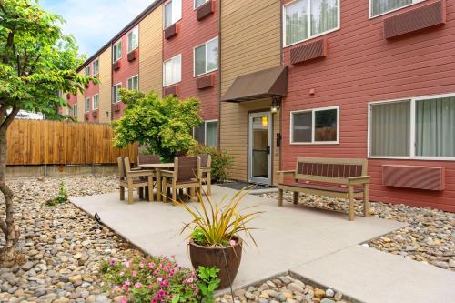 a patio with a table and benches in front of a building at Best Western Plus Yakima Hotel in Yakima