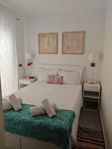 a bedroom with a bed with two pillows on it at The Sunny Cottage by Freetimealgarve in Faro