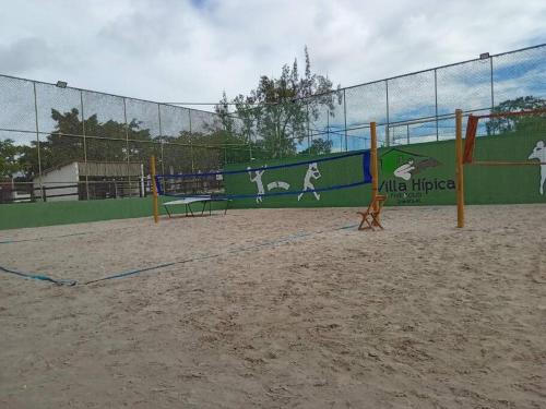 a playground with a fence and a volleyball court at Flat 207 Villa Hípica - Gravatá in Gravatá