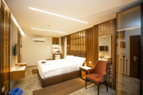 a hotel room with a bed and a chair at New Comfort Inn Giza in Cairo