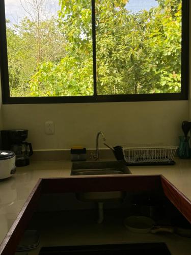 a kitchen with a sink and a window at Luz de Estrella Studios in Cabuya