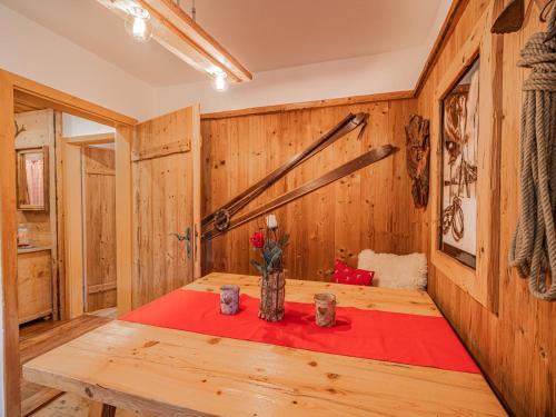 a wooden room with a table with a red blanket at Hilde 2 in Litzlfelden
