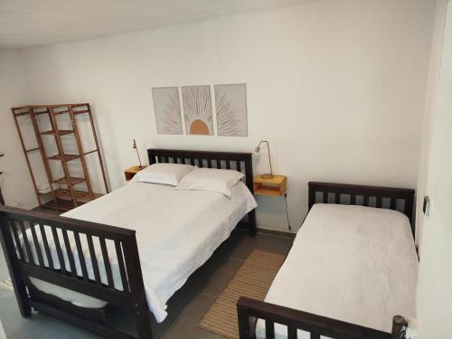a bedroom with two beds and a ladder on the wall at Sítio La Paz in Morretes