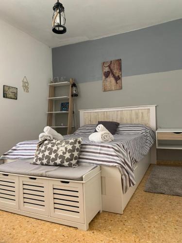 a bedroom with a white bed with pillows on it at Apartamento maspalomas 3 hab stay in gran canaria in Maspalomas