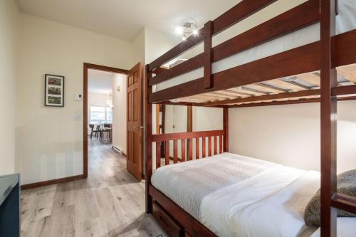 a bedroom with two bunk beds and a hallway at Deer Run by Outpost Whistler in Whistler
