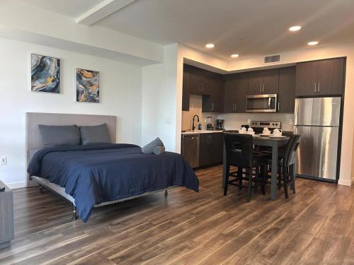 a bedroom with a bed and a table and a kitchen at Awesome Loft at Hollywood FREE Parking in Los Angeles