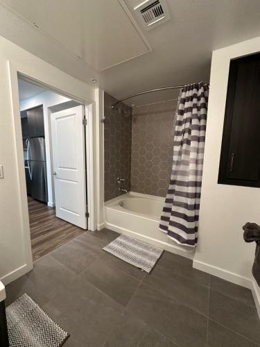 a bathroom with a bath tub in a room at Awesome Loft at Hollywood FREE Parking in Los Angeles