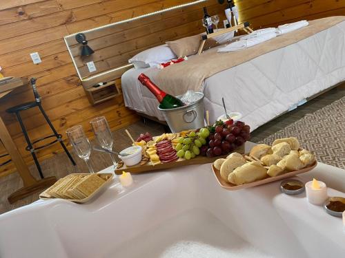 a table with a tray of food on it next to a bed at Cabanas Colina Do Sol in Cambara do Sul
