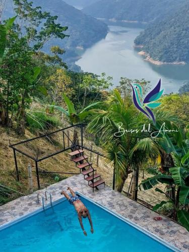 a swimming pool with a view of a river at EcoHotel Brisas del Amani in Norcasia