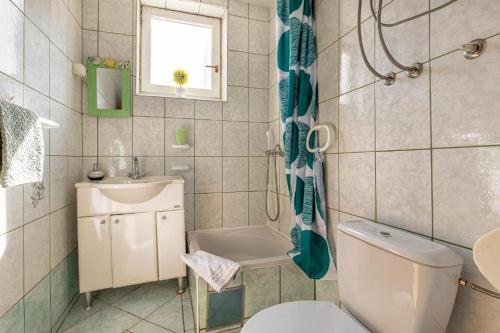 a bathroom with a toilet and a sink at Apartmani Alenka in Šibenik