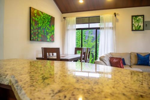 a kitchen and living room with a large marble counter top at Bukala Village Lodge in San Ramón