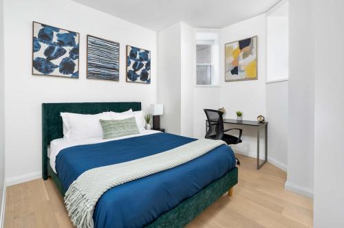 a bedroom with a blue and white bed and a desk at Hidden Gem - 3 BR Steps to Little Italy and UofT in Toronto