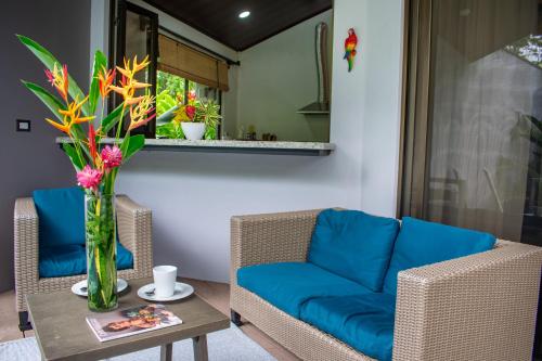 a living room with a couch and a table at Bukala Village Lodge in San Ramón