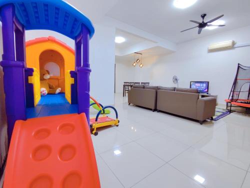 a living room with a play room with a playset at Spacious Family House at Desaru Harmonia 2 in Desaru