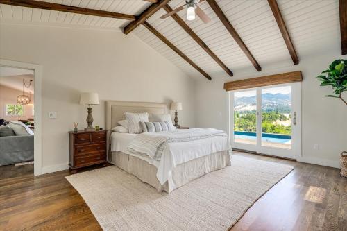 a bedroom with a bed and a large window at Calistoga Vista A Wine Country Escape in Calistoga