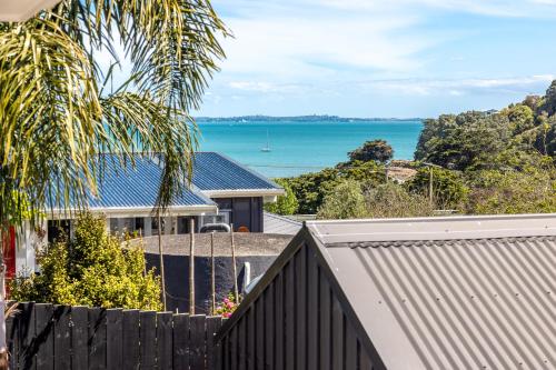 a view of the ocean from a house at Aloha Cottage with Pool & Spa, Waiheke in Oneroa