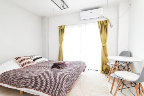 Ένα ή περισσότερα κρεβάτια σε δωμάτιο στο FIKA Shibuya Honmachi 102