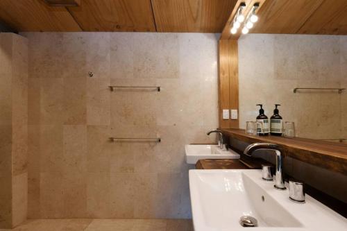 a bathroom with a sink and a mirror at Upper House in Maleny