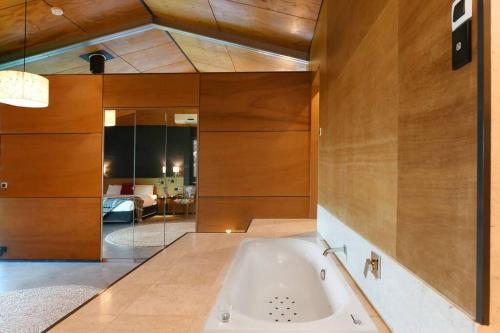 a bathroom with a bath tub in a room at Upper House in Maleny