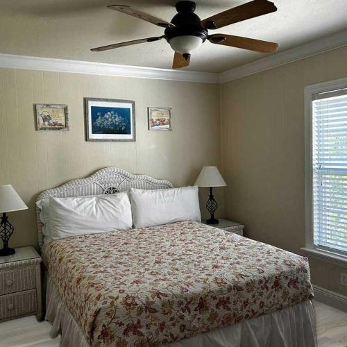 a bedroom with a bed with a ceiling fan at Tortuga Inn Beach Resort Unit #229 in Bradenton Beach
