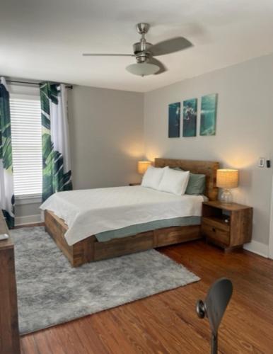 a bedroom with a bed and a ceiling fan at Habersham Hideaway in Savannah