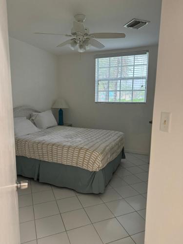 a bedroom with a bed and a ceiling fan at Sunset Cove - Vacation In Paradise! in Nassau
