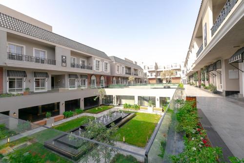 an empty courtyard of an apartment building with a garden at Layali Properties - Vibrant Boho 3BR Apt - Convention and Exhibition Center in Riyadh