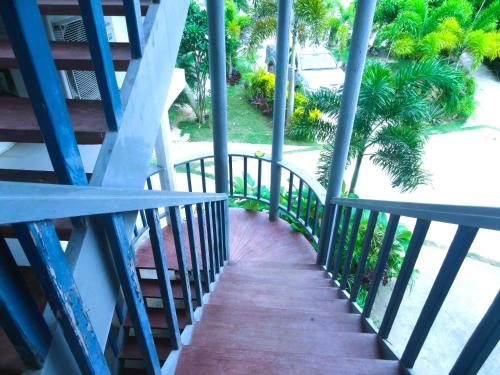 a staircase leading up to the balcony of a house at MG Chateau Resort in El Nido
