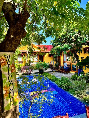a house with a pool of blue water at La Belle An Bang Seaside Hideaway in Hoi An