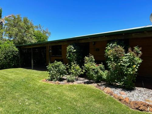 a house with a yard with bushes in front of it at Tea Tree - Pet Friendly - Prevelly - Margaret River in Margaret River Town