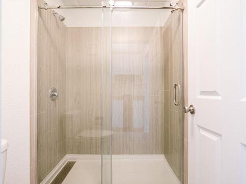 a shower with a glass door in a bathroom at Welcoming 1BR Gateway Orlando 5 minutes to Disney in Vineland