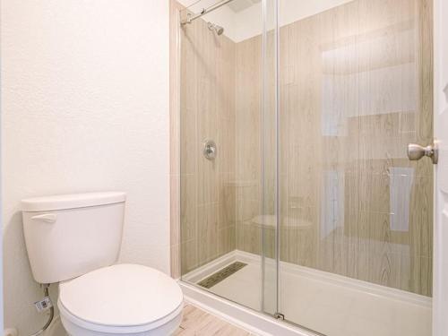 a bathroom with a toilet and a glass shower at Welcoming 1BR Gateway Orlando 5 minutes to Disney in Vineland
