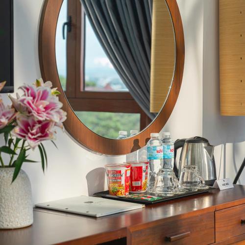 a desk with a mirror and a laptop on it at Duy Long Hotel in Da Lat
