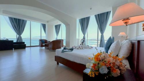 a hotel room with a bed with flowers on it at Nha Trang Lodge Hotel in Nha Trang