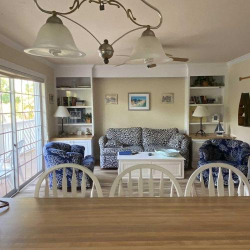 a living room with a couch and two chairs at Tortuga Inn Beach Resort Unit #229 in Bradenton Beach