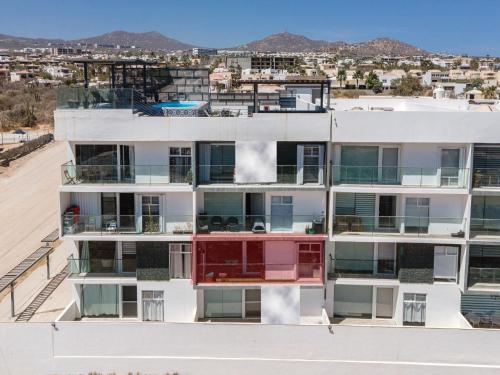 an apartment building with colorful balconies and a city at Cabo 16 in Cabo San Lucas