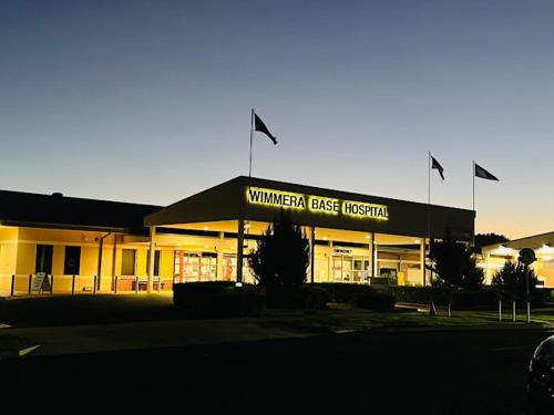 a building with flags in front of it at Evergreen On Baillie in Horsham