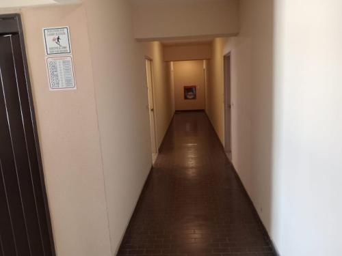 an empty hallway with a long corridor with a long floor at Departamento Recoleta Centro in Santa Fe