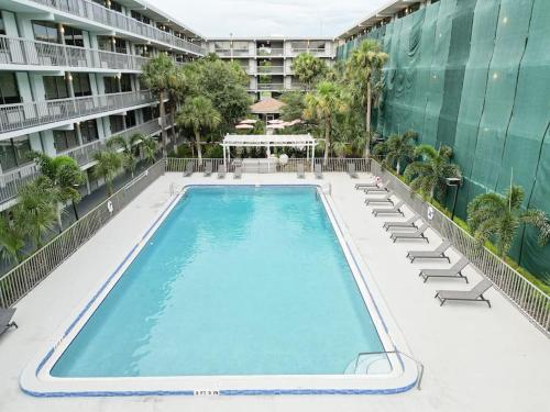 an empty swimming pool with lounge chairs and a building at Comfy 1BR Space in Orlando & 5 minutes to Disney in Vineland