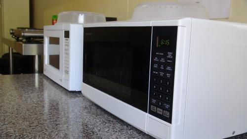 two white microwaves are sitting on a counter at Gariwerd Motel in Halls Gap