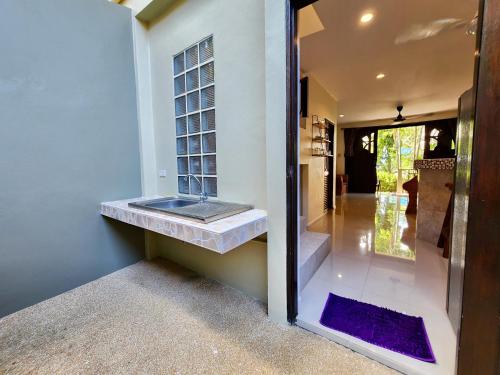 a bathroom with a sink on the side of a house at Soleil D'asie Residence in Chaweng Noi Beach