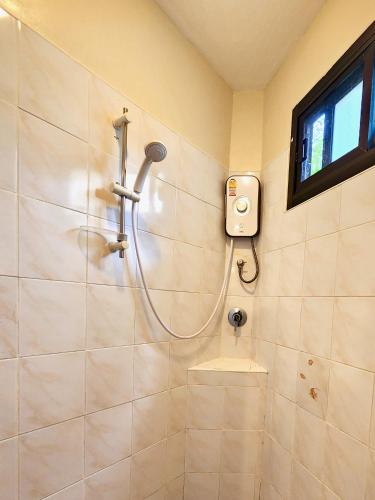 a shower in a bathroom with a window and a sink at Soleil D'asie Residence in Chaweng Noi Beach